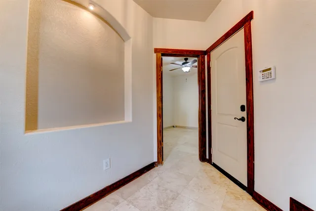 a view of a hallway with wooden floor and a hallway