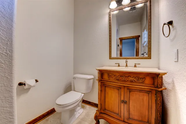 a bathroom with a sink a toilet and mirror