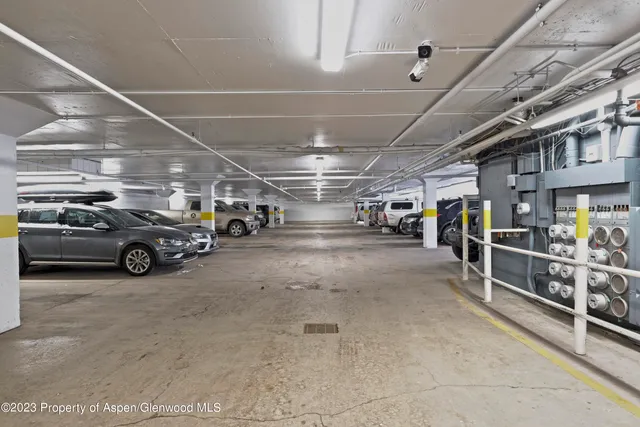 a view of parking garage with cars