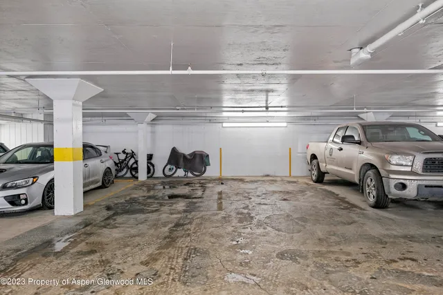 a view of parking garage with cars