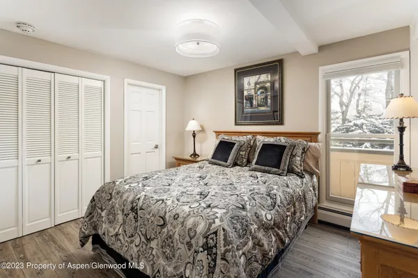 a bedroom with a large bed and a window