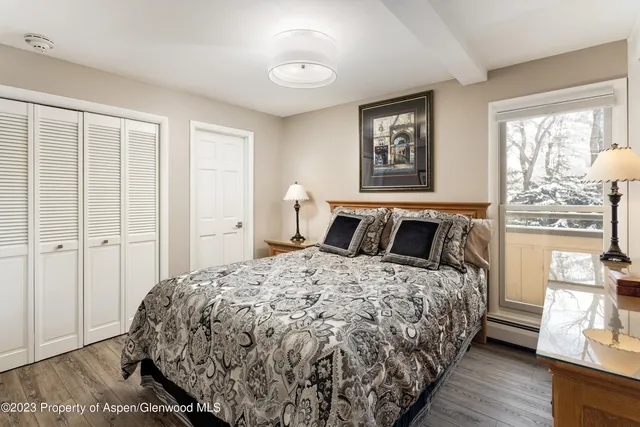 a bedroom with a large bed and a window