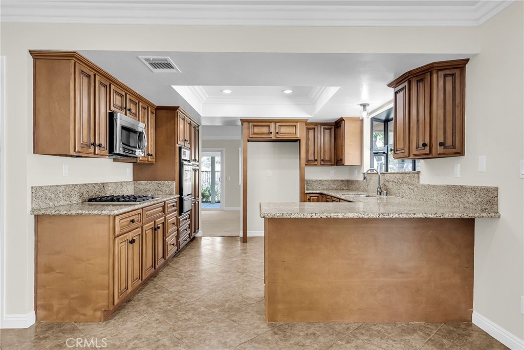 510 Vía Zapata Riverside, CA 92507 - Photo 13 of 47 a kitchen with stainless steel appliances granite countertop a stove top oven a sink a counter space and cabinets
