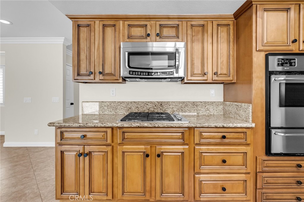 510 Vía Zapata Riverside, CA 92507 - Photo 14 of 47 a kitchen with granite countertop white cabinets and stainless steel appliances