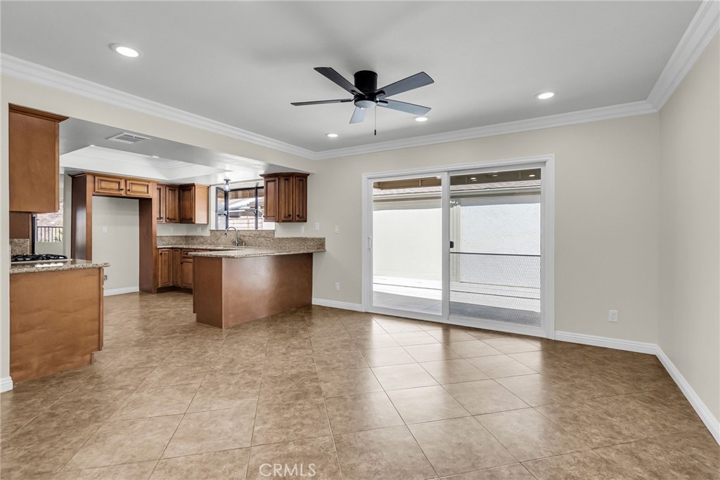 510 Vía Zapata Riverside, CA 92507 - Photo 15 of 47 a view of a kitchen with a stove cabinets a ceiling fan and wooden floor