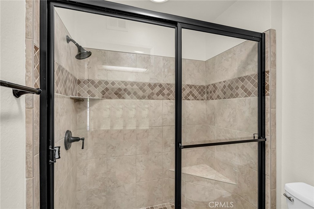 510 Vía Zapata Riverside, CA 92507 - Photo 26 of 47 a bathroom with a glass shower door