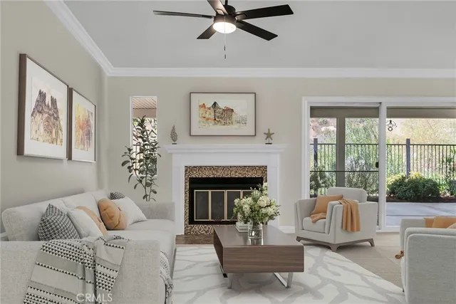 a living room with furniture a fireplace and a large window