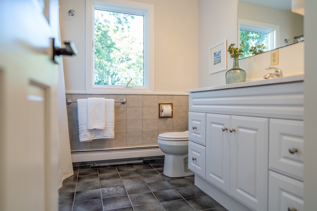 364 Lower County Road Harwich Port, MA 02646 - Photo 33 of 41 a bathroom with a toilet a sink and a window