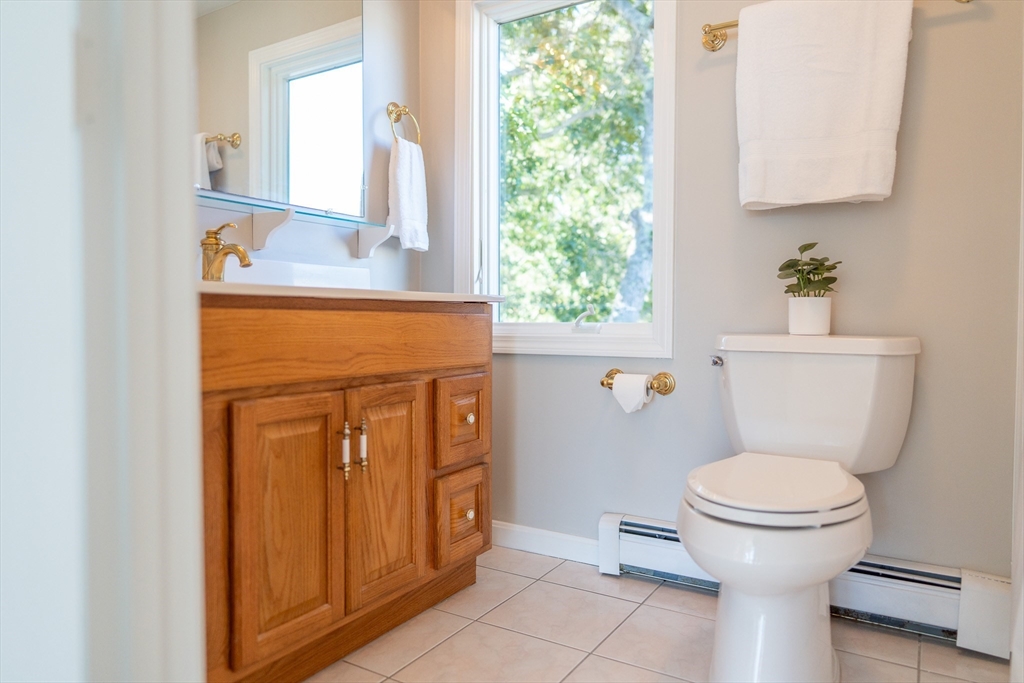 364 Lower County Road Harwich Port, MA 02646 - Photo 35 of 41 a bathroom with a granite countertop toilet sink and mirror