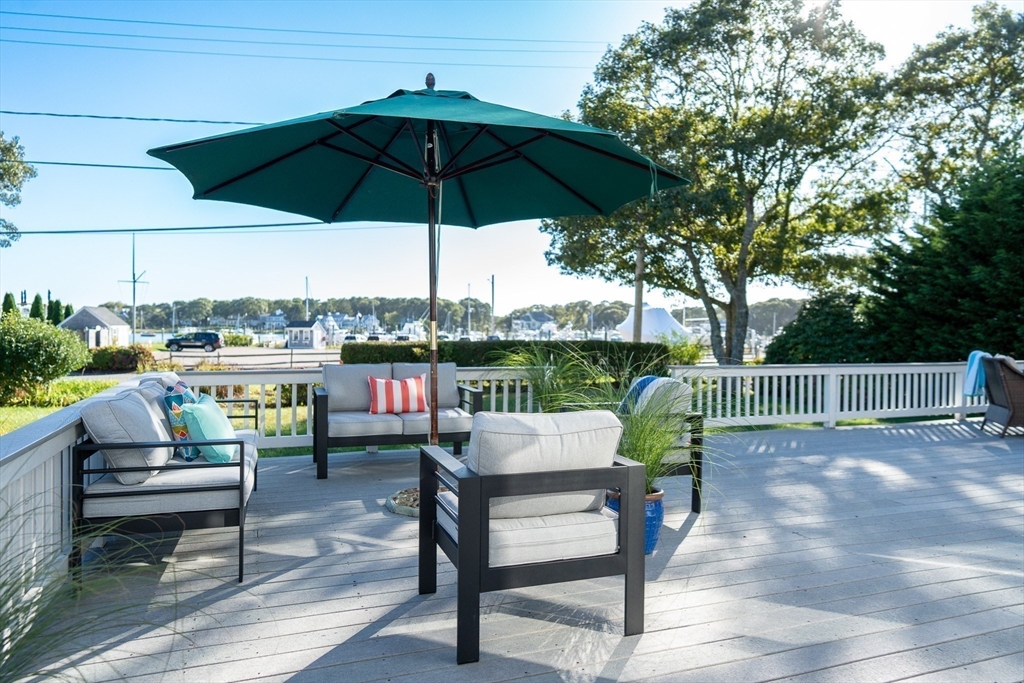 364 Lower County Road Harwich Port, MA 02646 - Photo 37 of 41 a view of a chairs and table in the back yard