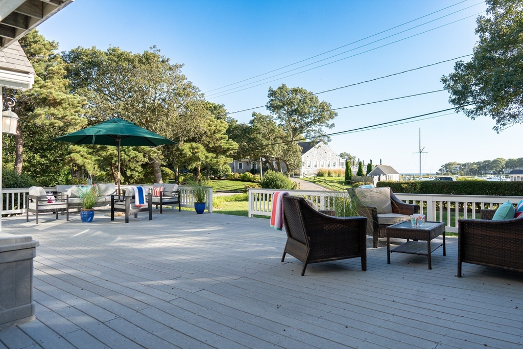 364 Lower County Road Harwich Port, MA 02646 - Photo 38 of 41 a view of a swimming pool with a table and chairs