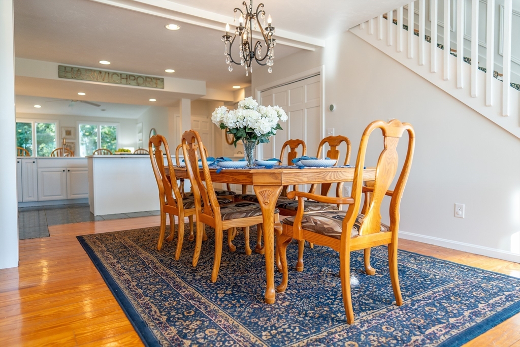 364 Lower County Road Harwich Port, MA 02646 - Photo 7 of 41 a dining room with furniture a rug and a chandelier