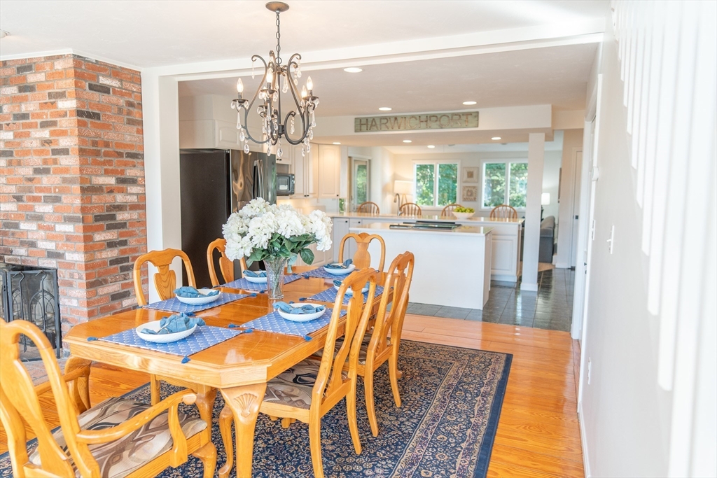 364 Lower County Road Harwich Port, MA 02646 - Photo 8 of 41 a dining room with furniture a chandelier and wooden floor