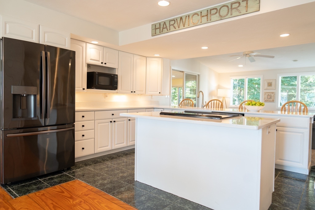 364 Lower County Road Harwich Port, MA 02646 - Photo 9 of 41 a kitchen with stainless steel appliances a refrigerator sink and cabinets