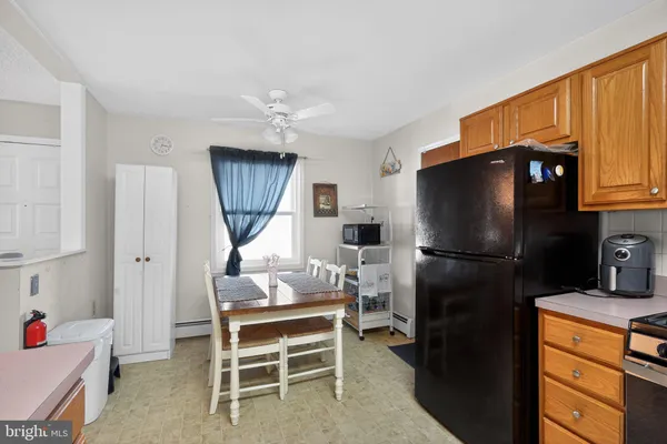 a kitchen with stainless steel appliances a refrigerator and a stove top oven