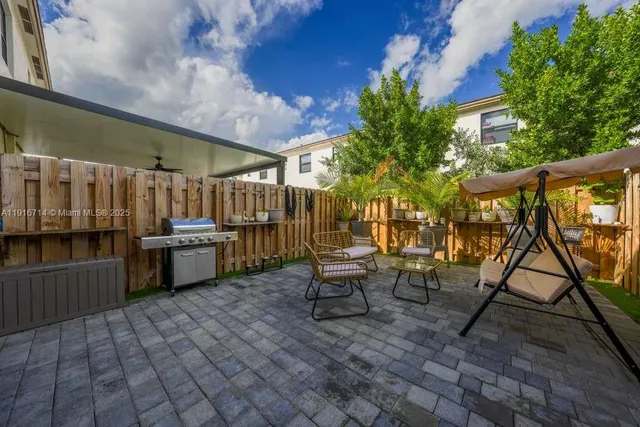 a view of a chairs and table in the patio