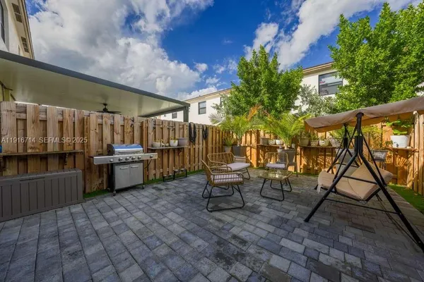 a view of a chairs and table in the patio
