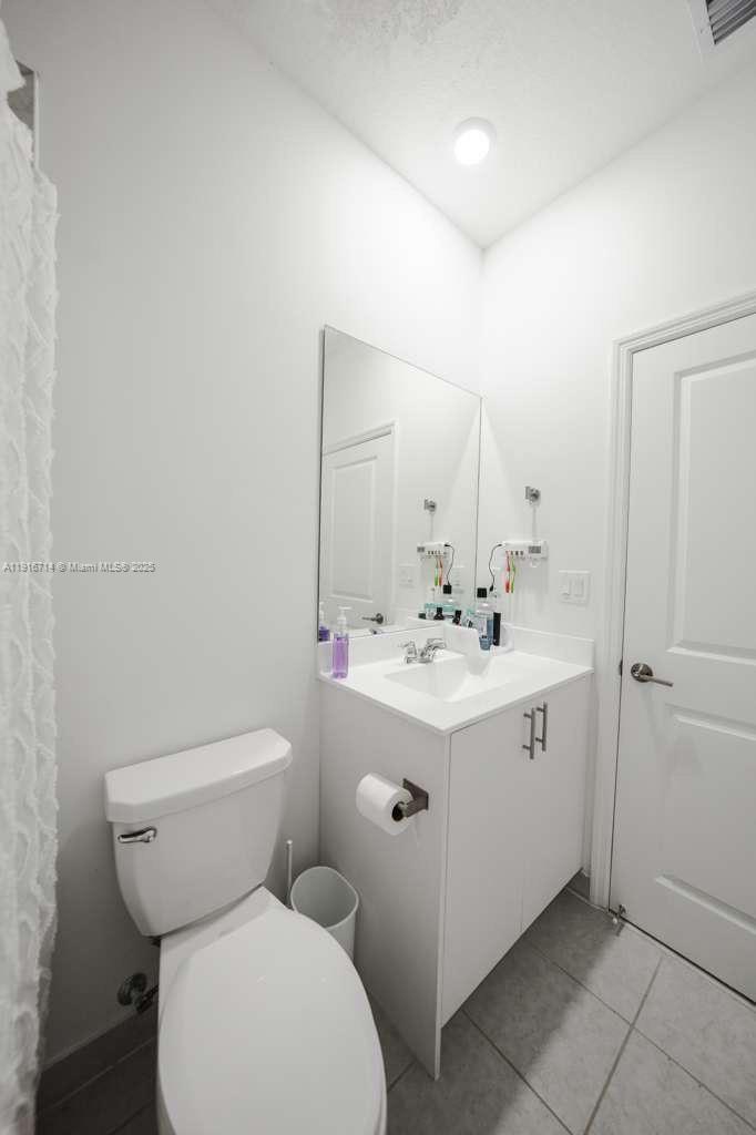 12869 Southwest 233rd Terrace Homestead, FL 33032 - Photo 25 of 30 a bathroom with a toilet sink and mirror