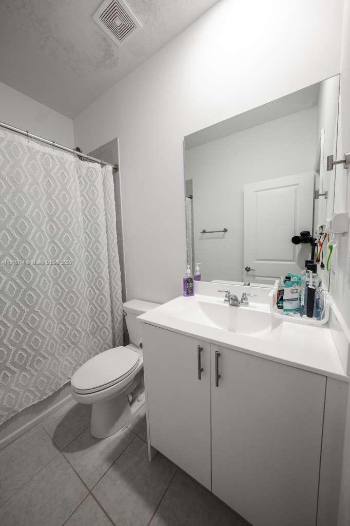 12869 Southwest 233rd Terrace Homestead, FL 33032 - Photo 26 of 30 a bathroom with a sink toilet and mirror