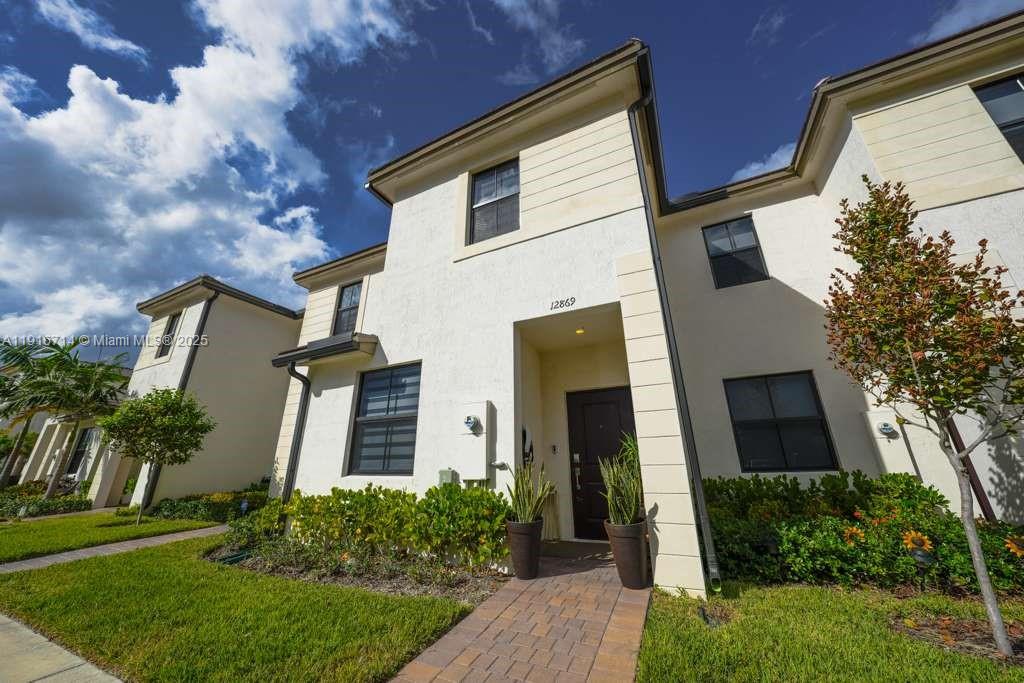 12869 Southwest 233rd Terrace Homestead, FL 33032 - Photo 27 of 30 front view of a house with a yard