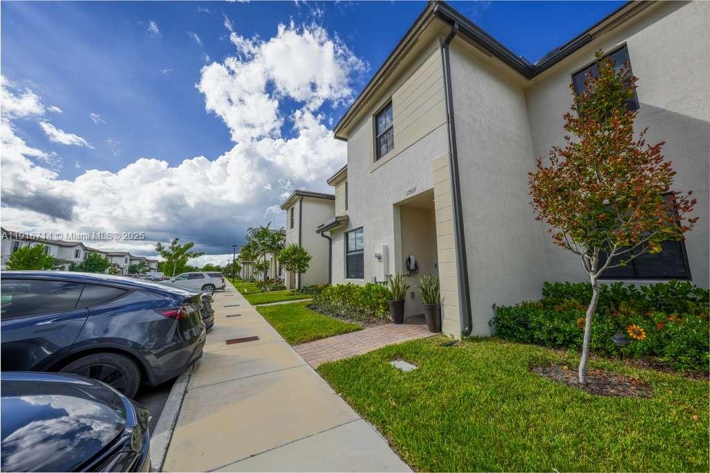 12869 Southwest 233rd Terrace Homestead, FL 33032 - Photo 28 of 30 a view of a house with a cars park