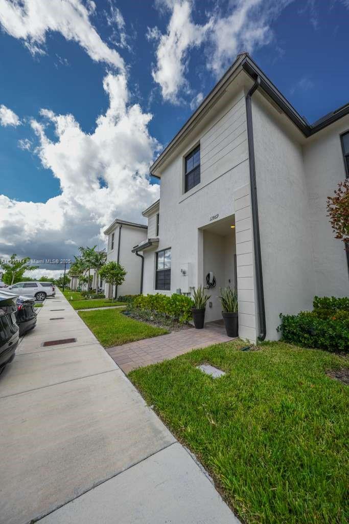 12869 Southwest 233rd Terrace Homestead, FL 33032 - Photo 29 of 30 a view of a house with a yard