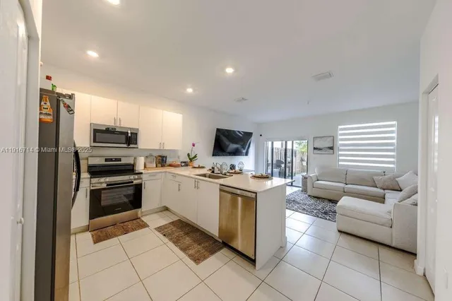 a kitchen with a sink and stainless steel appliances
