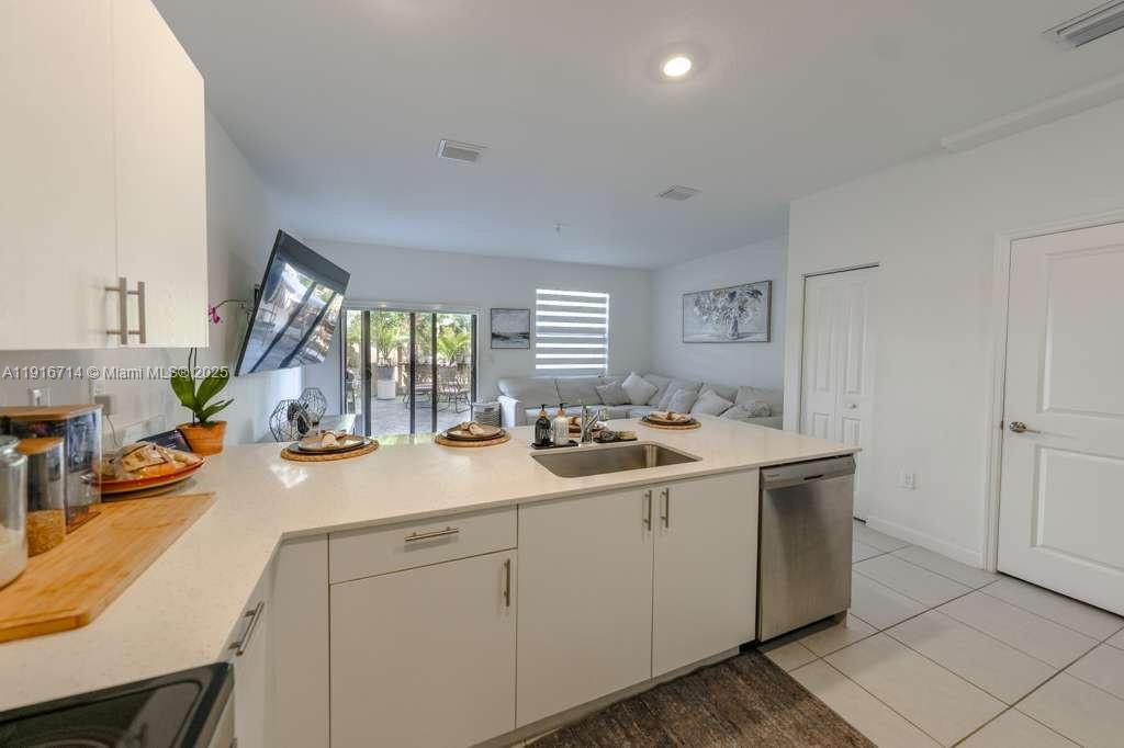 12869 Southwest 233rd Terrace Homestead, FL 33032 - Photo 8 of 30 a view of a sink and dishwasher with wooden floor