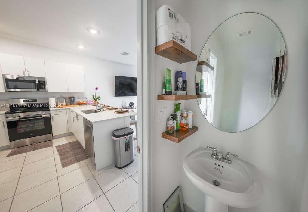 12869 Southwest 233rd Terrace Homestead, FL 33032 - Photo 9 of 30 a kitchen with a sink appliances and cabinets