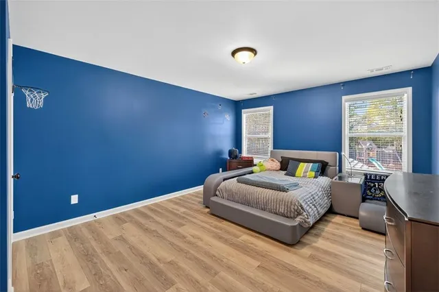 a view of a hallway with entryway wooden floor and front door