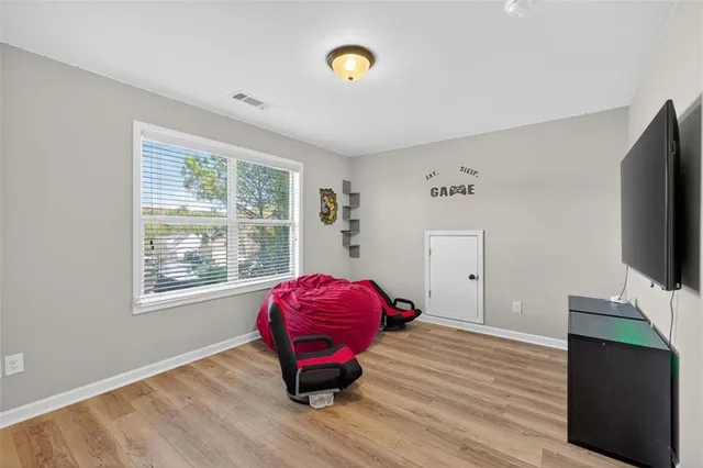 an aerial view of residential houses with outdoor space and trees