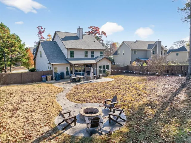 an aerial view of a house with swimming pool and outdoor seating