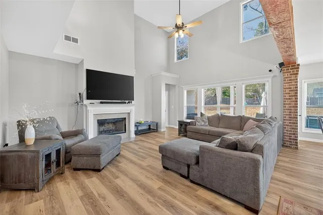 a living room with furniture a fireplace and a flat screen tv