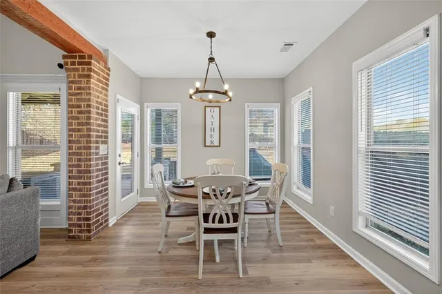 a dining room with furniture window and wooden floor