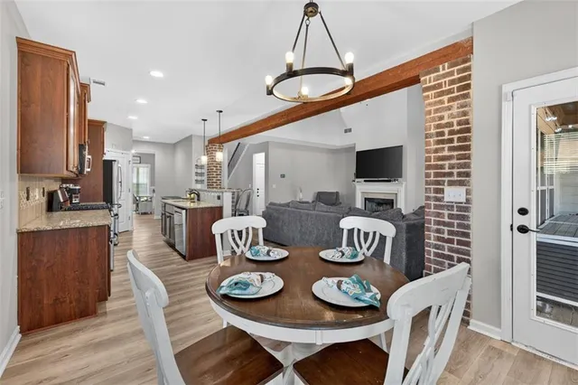a kitchen with a dining table and chairs