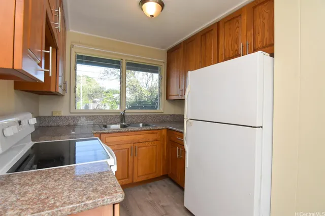 a kitchen with stainless steel appliances a refrigerator and a sink