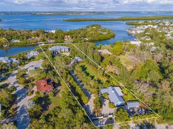 an aerial view of multiple houses with yard