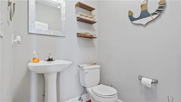 a bathroom with a sink mirror and toilet