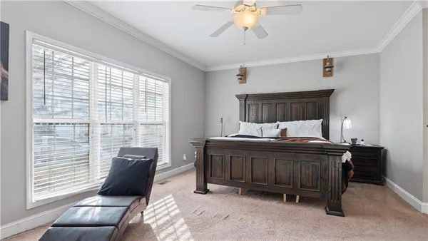 a bed sitting in a bedroom next to a window