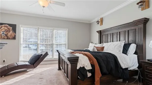 a bed room with a bed and a chair