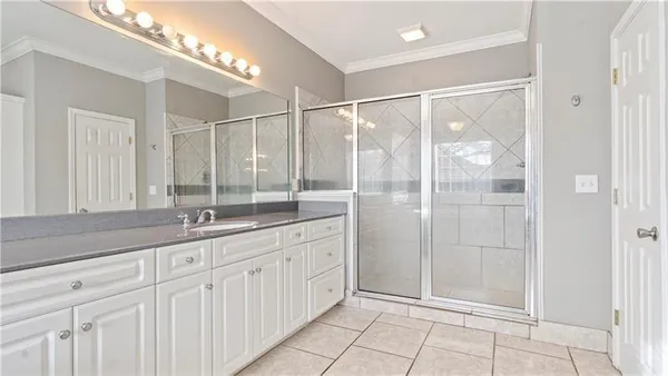 a bathroom with a shower sink and mirror