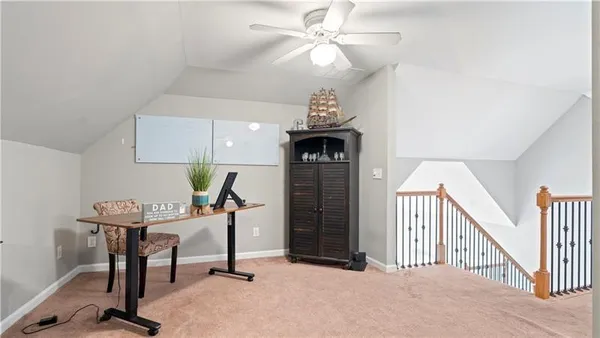 a view of a workspace with furniture and a chandelier fan