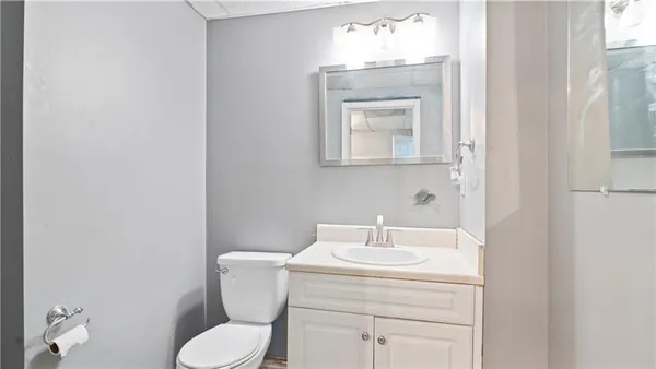 a bathroom with a toilet sink and mirror