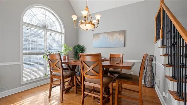 a view of a dining room with furniture and a chandelier