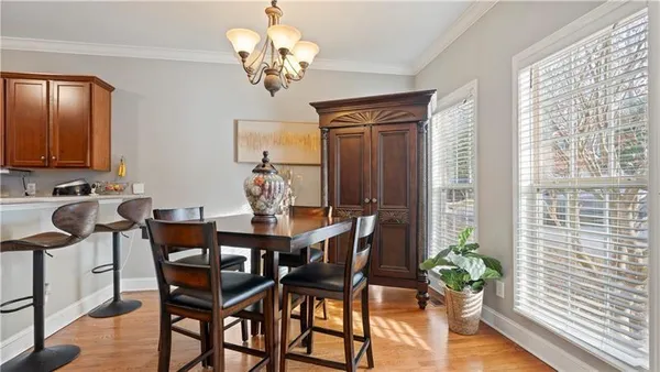 a view of a dining room with furniture and chandelier