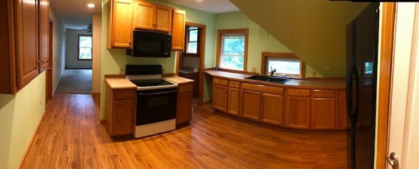 a kitchen with granite countertop a stove top oven and sink