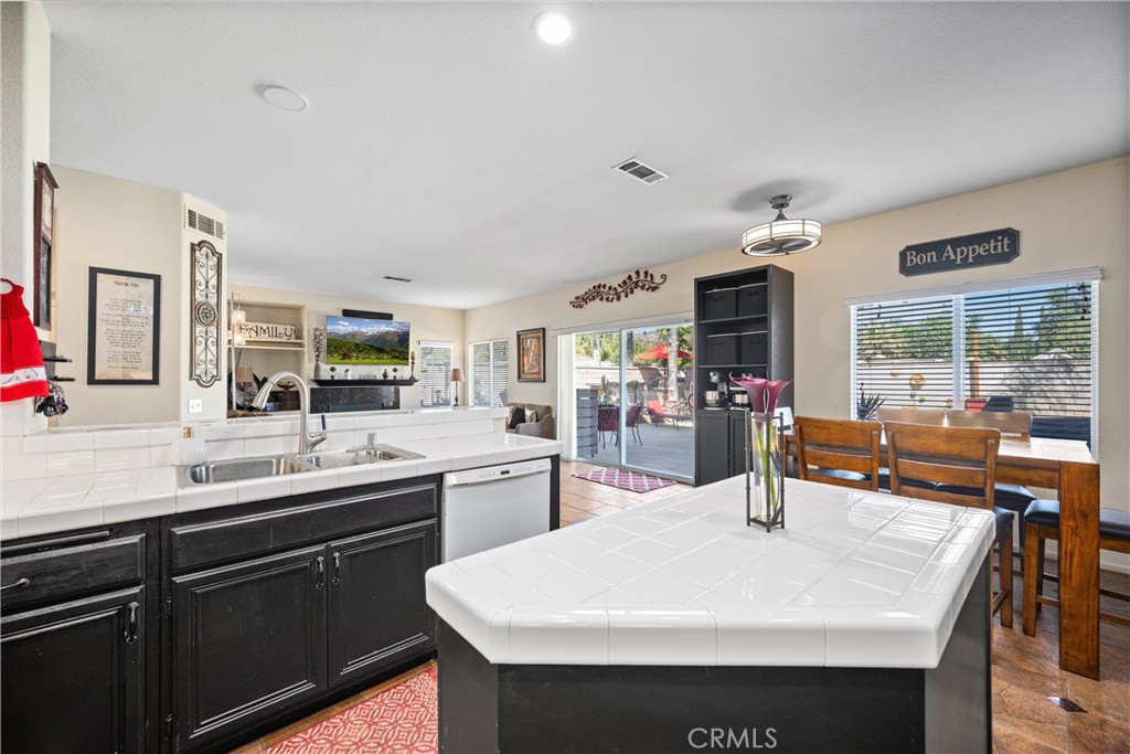 32853 Starlight Street Wildomar, CA 92595 - Photo 12 of 32 a kitchen with stainless steel appliances a sink and stove