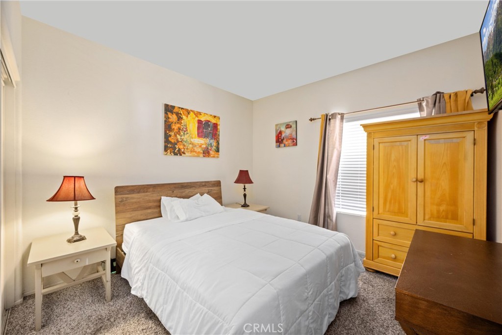 32853 Starlight Street Wildomar, CA 92595 - Photo 17 of 32 a bedroom with a bed and wooden floor