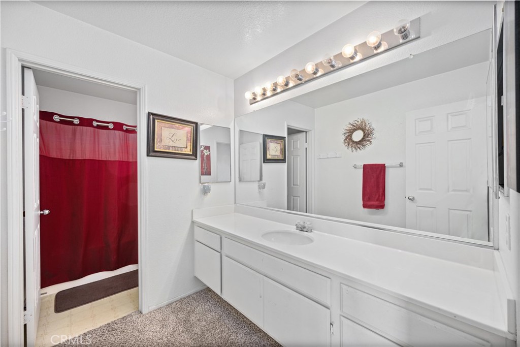 32853 Starlight Street Wildomar, CA 92595 - Photo 22 of 32 a bathroom with a sink vanity and mirror