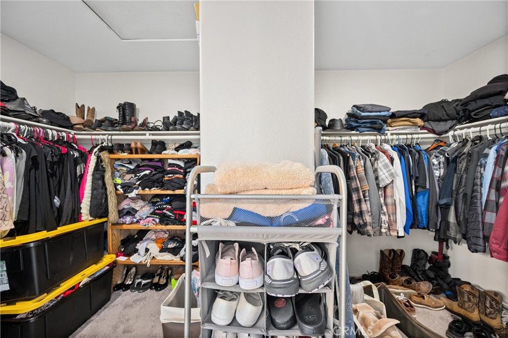 32853 Starlight Street Wildomar, CA 92595 - Photo 26 of 32 a view of walk in closet with clothes and shoes